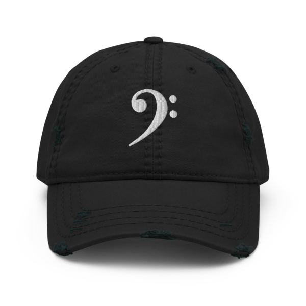 A black distressed dad hat featuring a white embroidered Bass Clef symbol on the front.