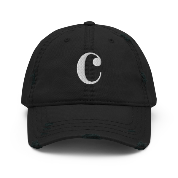 A distressed black dad hat with a white embroidered Common-Time musical symbol on the front.