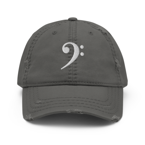 A black distressed dad hat featuring a white embroidered Bass Clef symbol on the front.