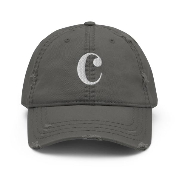A distressed black dad hat with a white embroidered Common-Time musical symbol on the front.