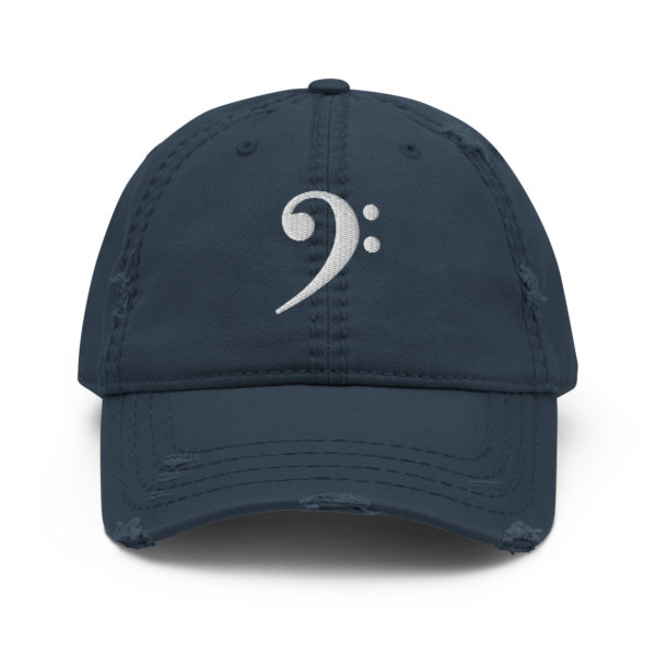 A black distressed dad hat featuring a white embroidered Bass Clef symbol on the front.