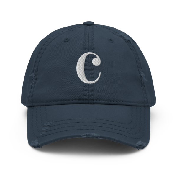 A distressed black dad hat with a white embroidered Common-Time musical symbol on the front.